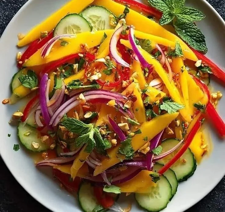 Zesty Thai Mango Salad with fresh mango, herbs, and spices on a plate.