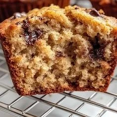 Delicious banana bread muffins with a golden brown top and fresh bananas.