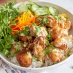 Bang Bang Chicken Rice Bowl with vibrant toppings and chicken