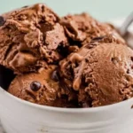 Delicious Chocolate Banana Ice Cream served in a bowl with fresh bananas and chocolate shavings.