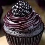 Dark chocolate blackberry cupcakes topped with fresh blackberries