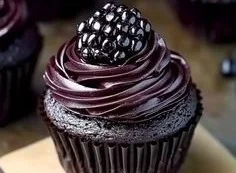 Dark chocolate blackberry cupcakes topped with fresh blackberries