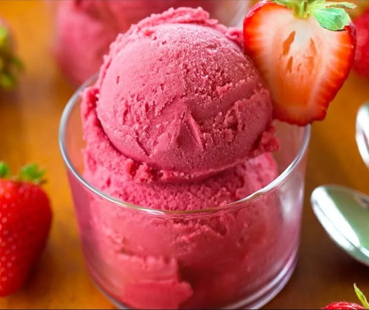 Bowl of easy 3-ingredient strawberry sorbet garnished with fresh strawberries