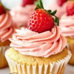 Delicious fresh strawberry cupcakes with cream frosting and whole strawberries on top