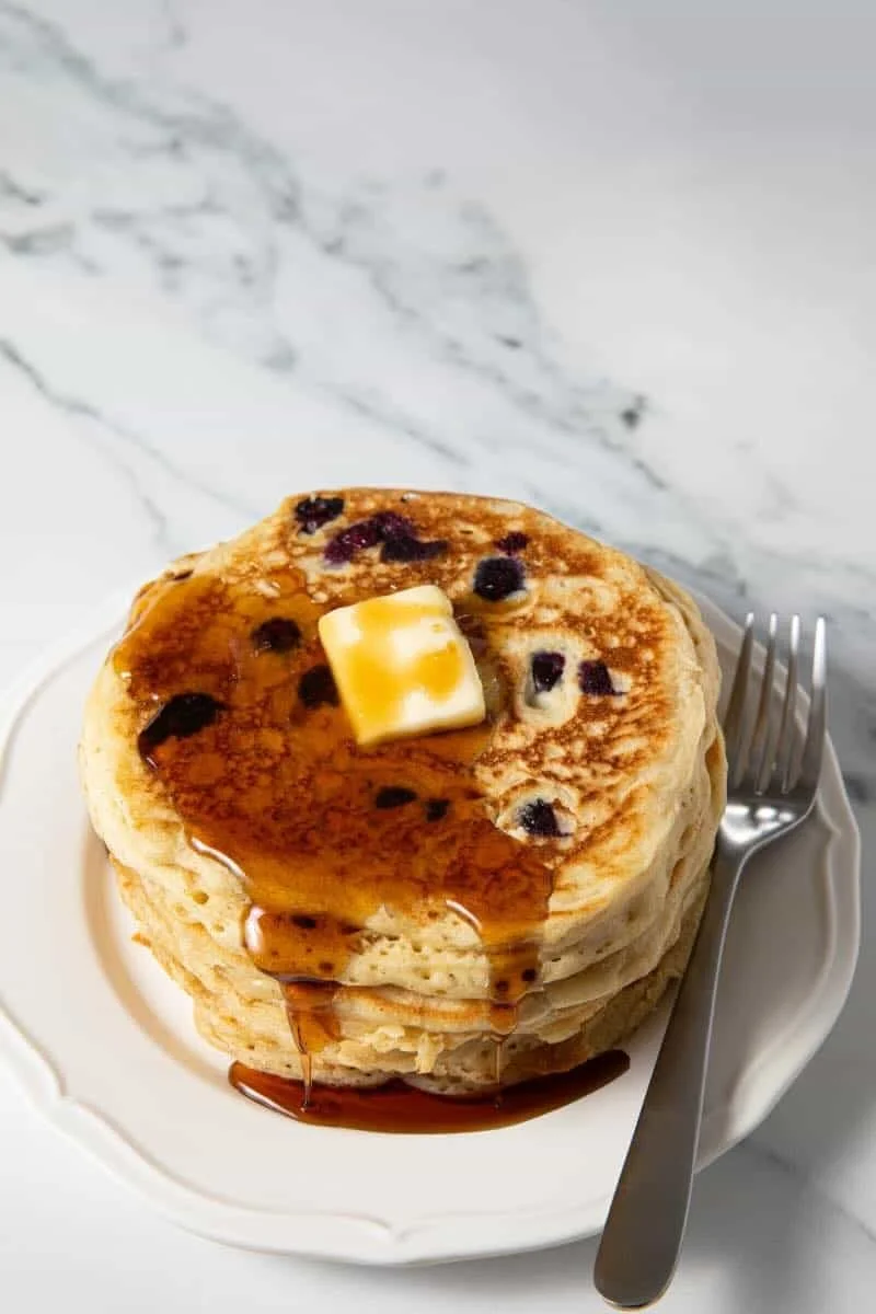 Gluten Free Blueberry Oatmeal Protein Pancakes topped with fresh blueberries