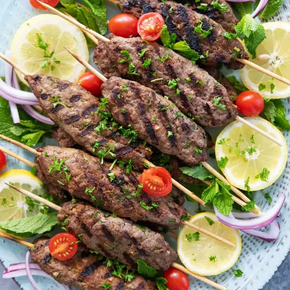 Delicious grilled kofta kebab served on a plate with fresh herbs and spices
