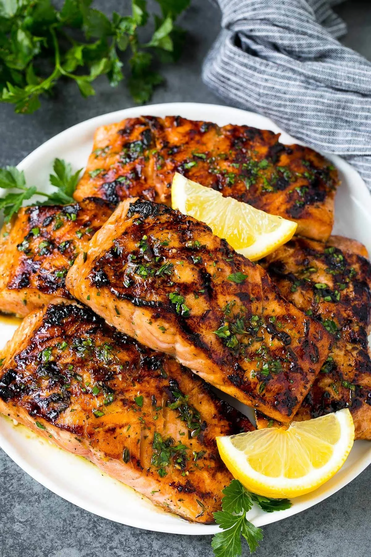 Delicious grilled salmon served with fresh herbs and lemon slices