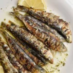 Delicious grilled sardines served with traditional Greek herbs and lemon.