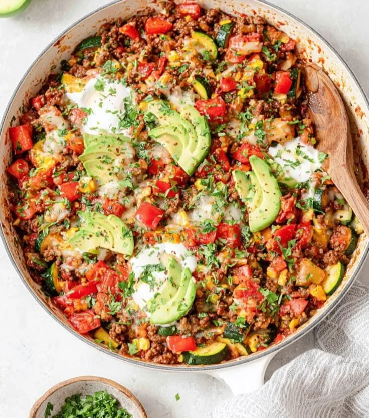 Ground beef and zucchini skillet cooked in a pan with vibrant vegetables.