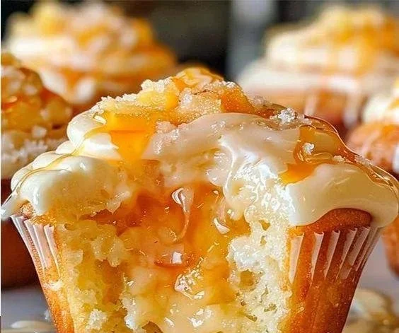 Delicious Honey Peach Cream Cheese Cupcakes topped with honey frosting