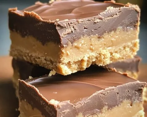 Homemade Reese's Peanut Butter Bars topped with chocolate and peanut butter.