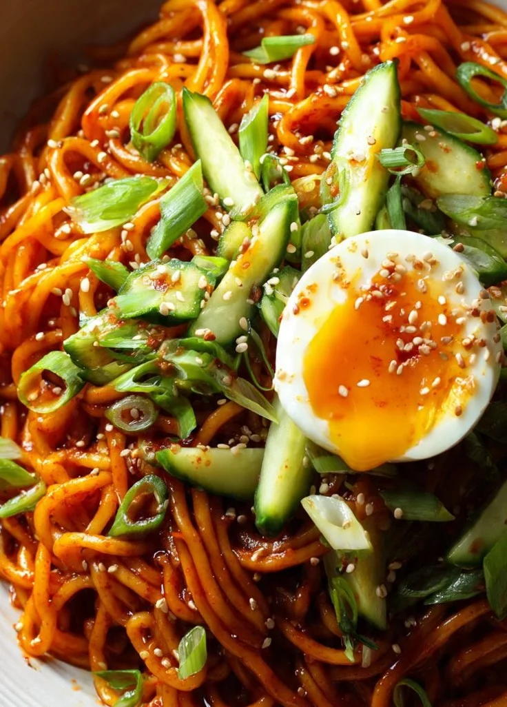 Bowl of flavorful Sesame Noodles with Gochujang sauce and garnishes.