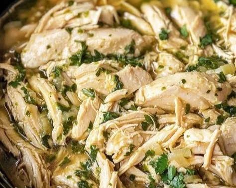 Slow Cooker Cilantro Lime Chicken dish garnished with fresh cilantro and lime
