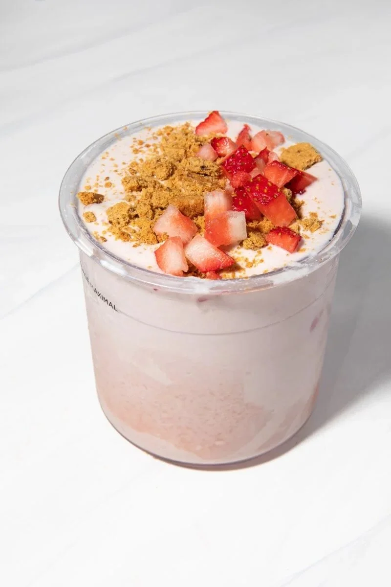 Strawberry Cheesecake Ninja Creami Protein Ice Cream in a bowl with fresh strawberries