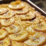Baked Banana Semolina Tray topped with banana slices and nuts
