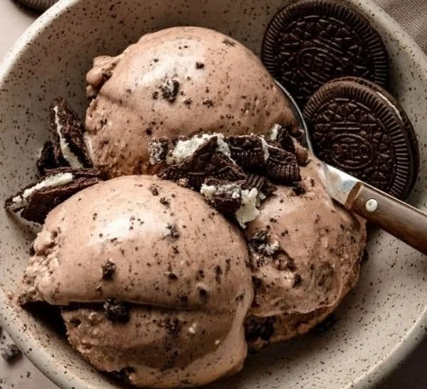 Delicious Chocolate Oreo Protein Ice Cream in a bowl with chocolate and Oreo toppings