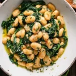Delicious Garlic Butter Beans with Spinach served in a bowl.
