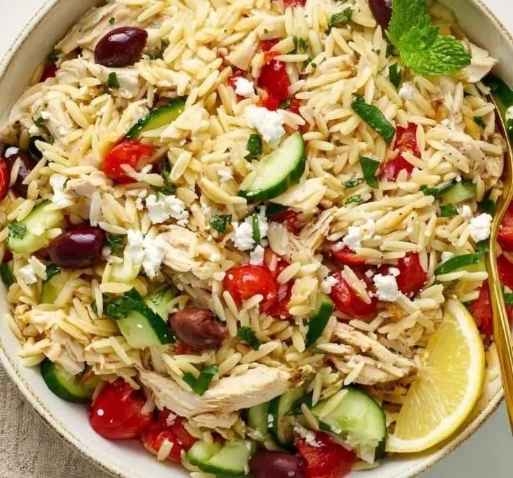 Delicious Greek Chicken Orzo Bowl with fresh vegetables and herbs