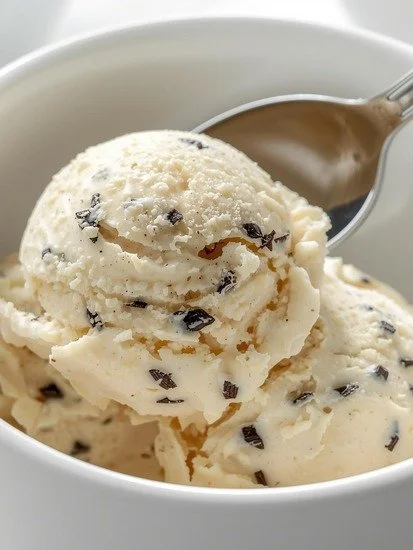 High protein vanilla bean ice cream in a bowl topped with fresh vanilla beans