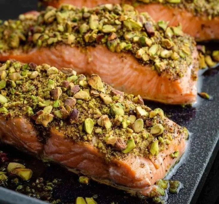 Delicious Maple Pistachio Salmon plated with herbs and garnishments