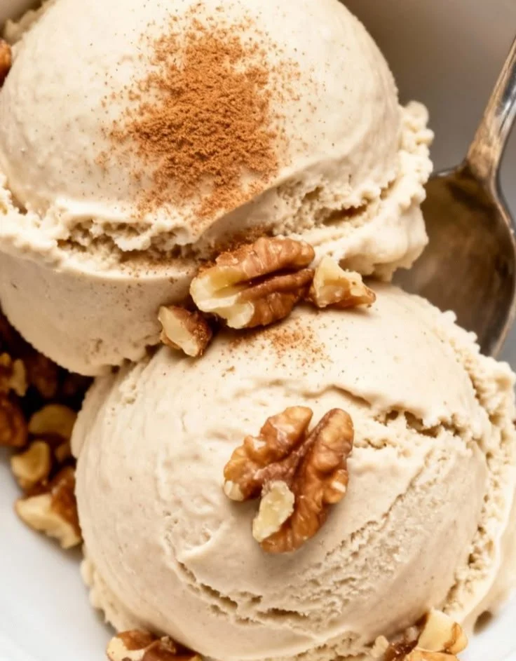 A bowl of Ninja Creami Banana Bread Protein Ice Cream topped with nuts