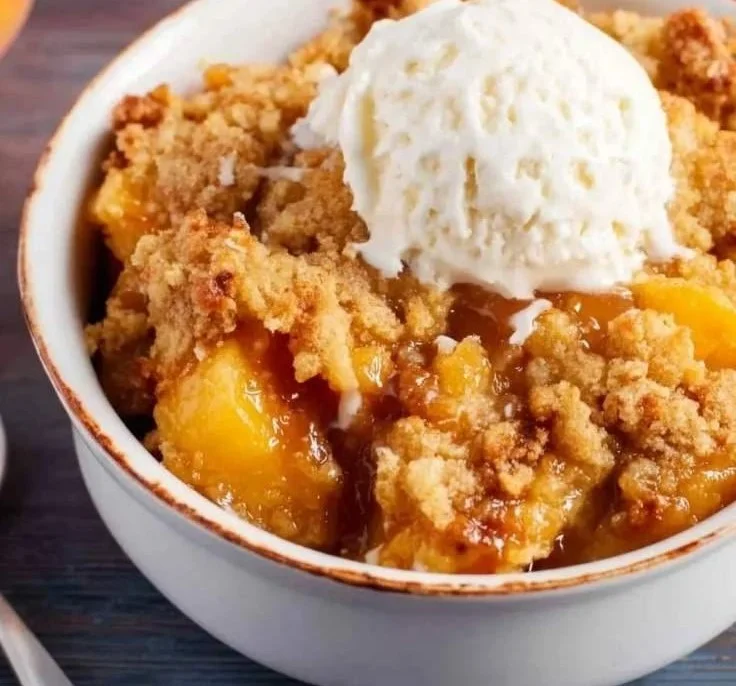 Delicious Peach Dump Cake served with a scoop of vanilla ice cream