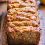 Peanut Butter Banana Bread with Apples on a wooden serving board