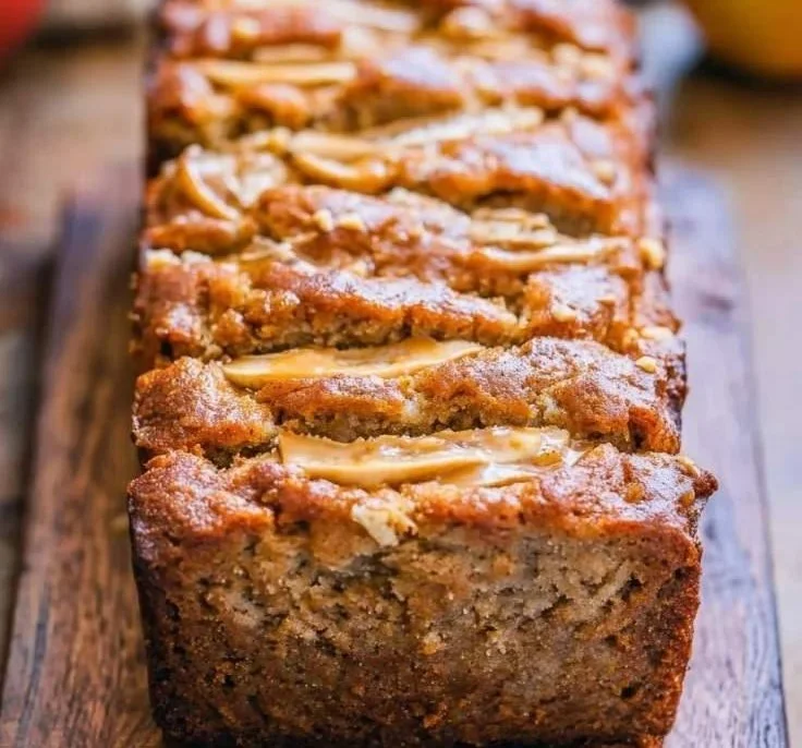 Peanut Butter Banana Bread with Apples on a wooden serving board