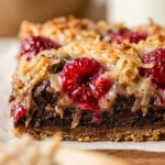 Delicious Raspberry Coconut Magic Bars on a plate