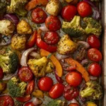 Colorful roasted vegetables on a sheet pan ready to serve.