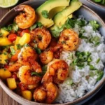 Delicious shrimp and rice bowl garnished with vegetables and herbs