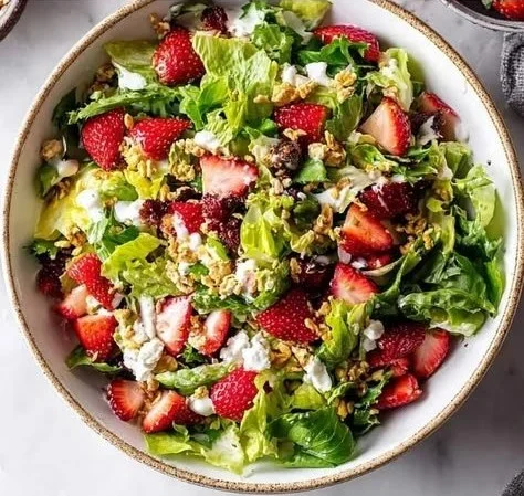 A vibrant Strawberry Crunch Salad with fresh strawberries and crunchy toppings.