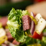 Colorful Italian Grinder Salad with fresh vegetables and dressing