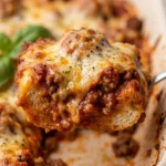 Delicious meatball sub casserole topped with melted cheese and marinara sauce